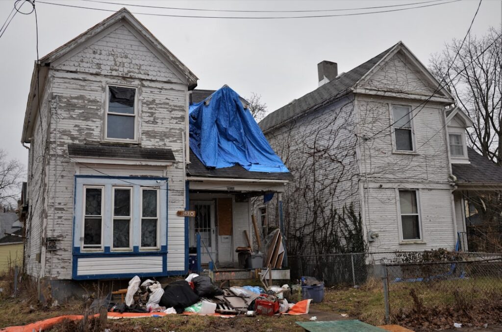 emergency roof tarp on storm damaged residential home - emergency roof tarp