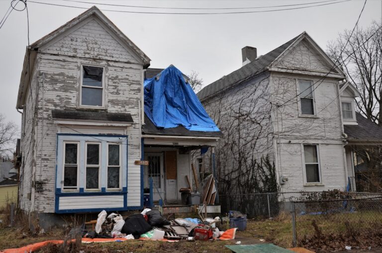 emergency roof tarp on storm damaged residential home - emergency roof tarp
